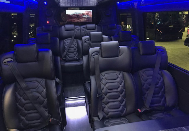 executive coach Mercedes Sprinter with leather seating, accent lighting, work table and TV