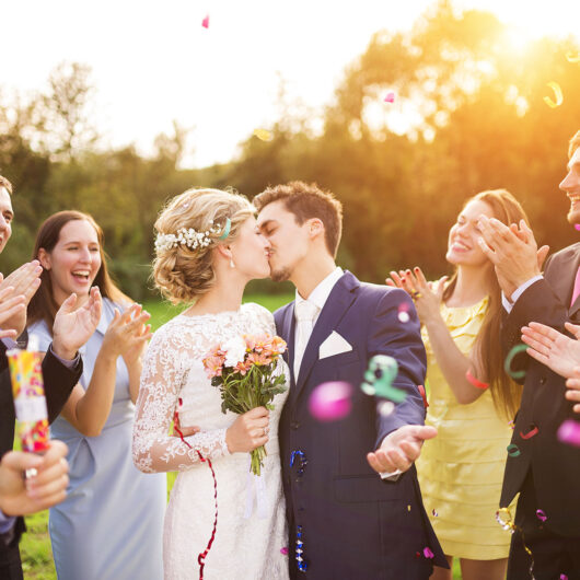 groom and bride kissing at the wedding ceremony