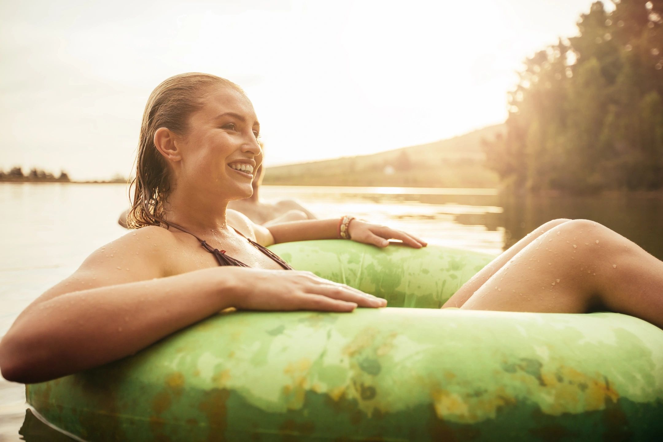 woman floating on an inner tube down a river