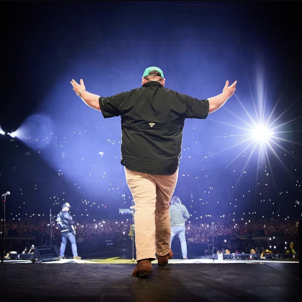 Luke Combs walking onto the stage at his concert