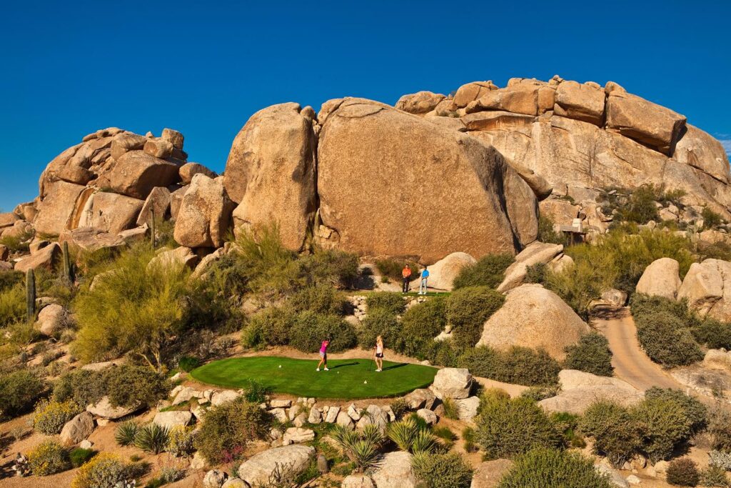 Rock formations surround the putting green and fairways a top golf course in Scottsdale: the Boulders